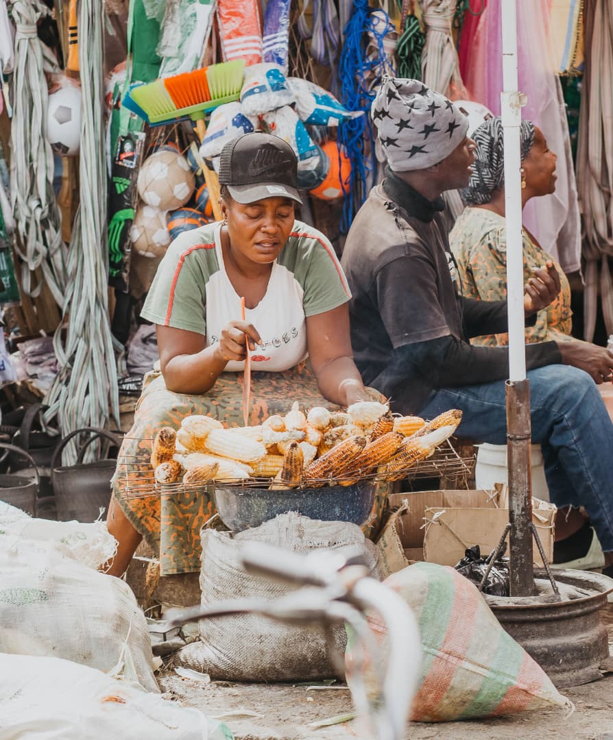 A woman roasting maize on a street corner in Arusha