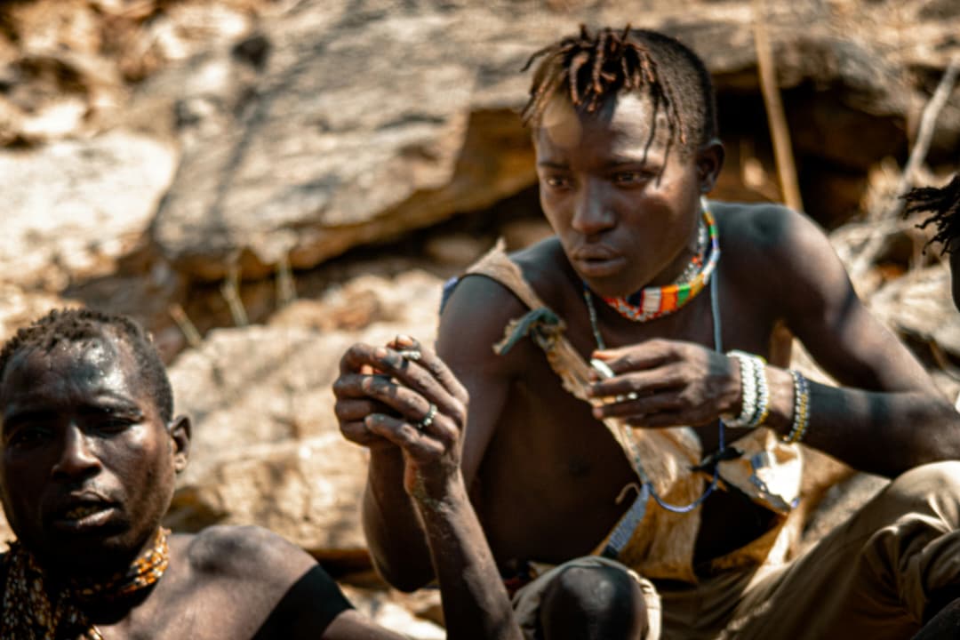 Hadzabe hunters resting among the rocks at Lake Eyasi